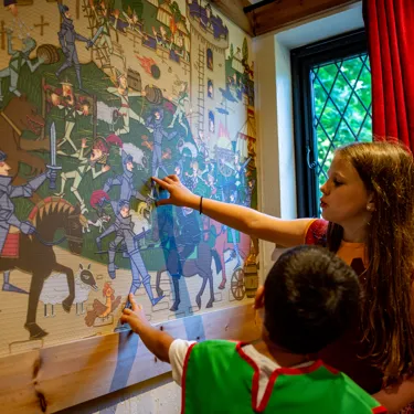 Children playing with wall art